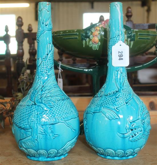 Pair of Burmantofts faience turquoise-glazed bottle vases, moulded with sinuous dragons (1 repaired rim)(-)